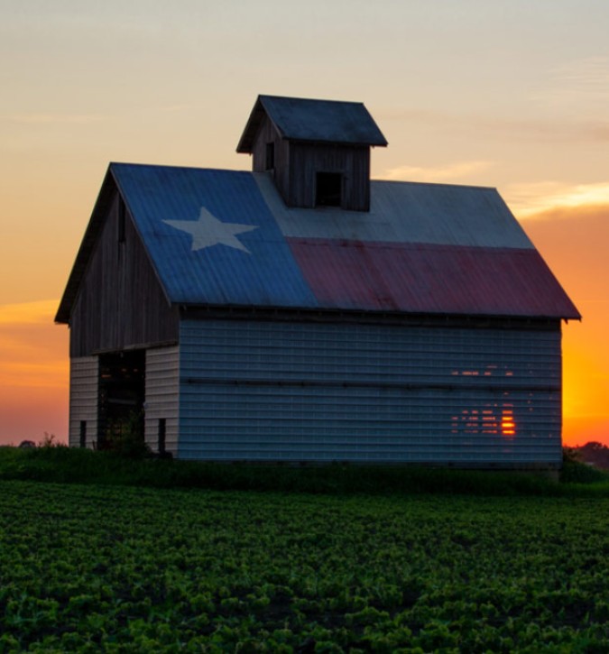 Texas state flag painted on the roof of a barn